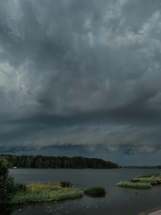 a cloudy sky is over a body of water