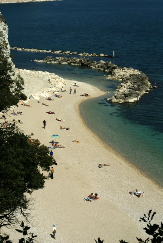 a beach with lots of people at the edge