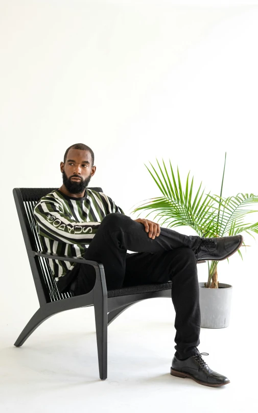 a man with a beard sitting in a chair