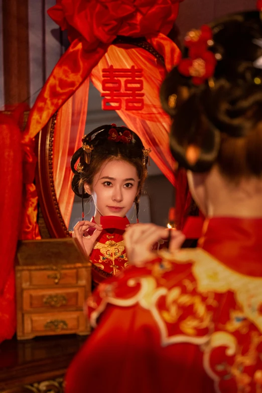 woman looking in the mirror wearing traditional chinese garb