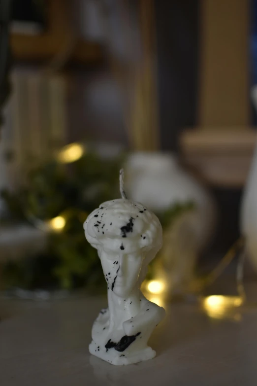 a white statue sitting on top of a table