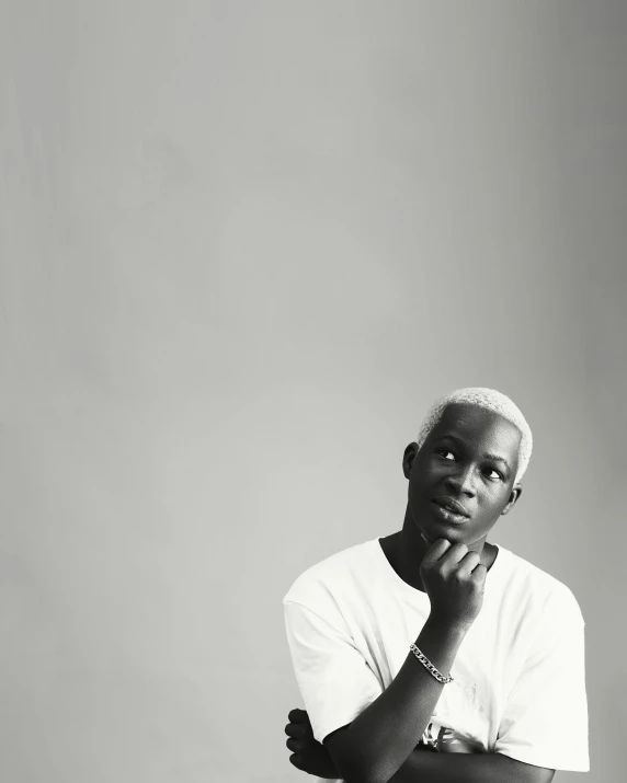 a man wearing a white shirt with his arms crossed in front of him