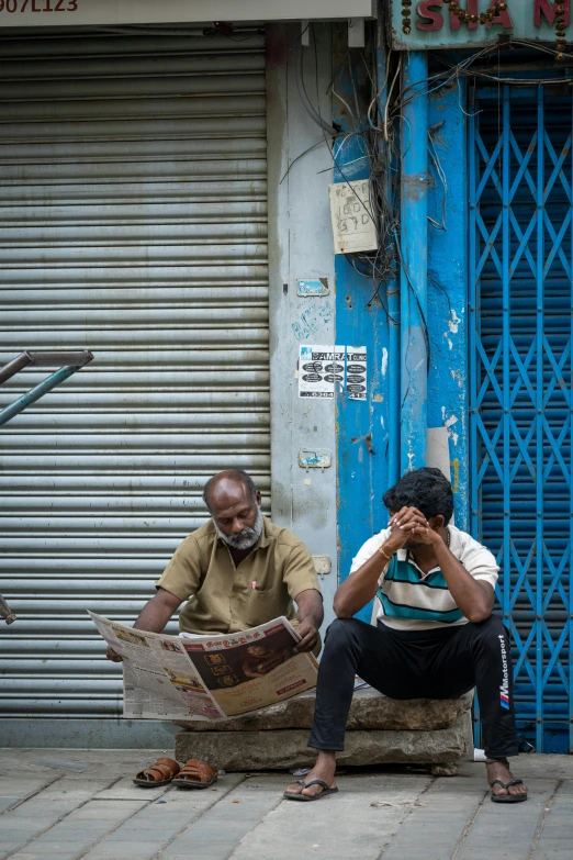 a man is sitting outside in the sun