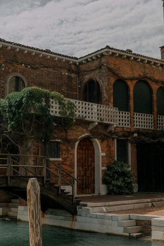 an old brick building next to a boat dock