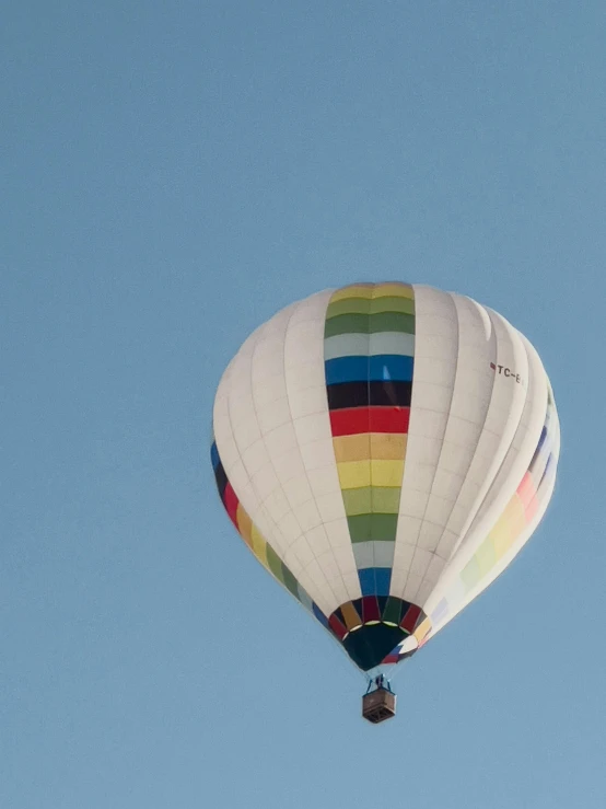 a colorful balloon rises in the sky