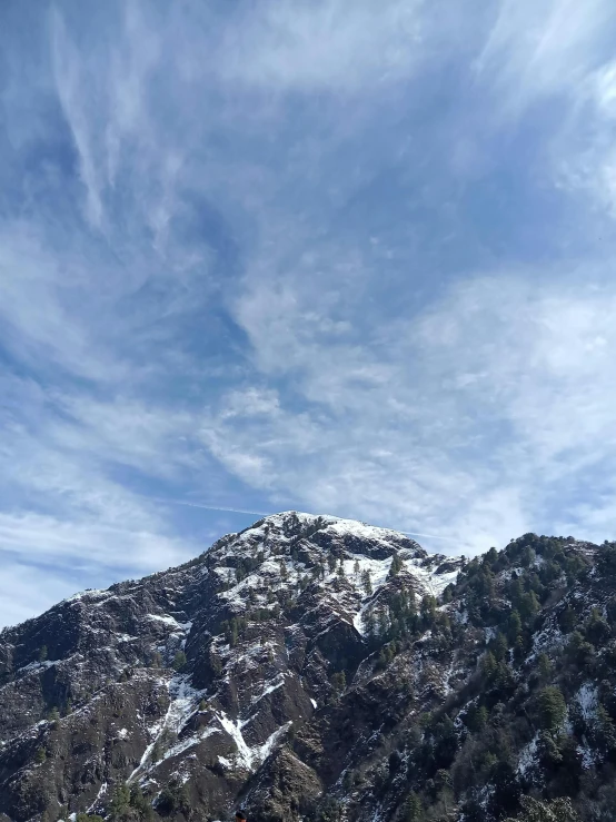 a scenic view of a mountain with snow on the tops