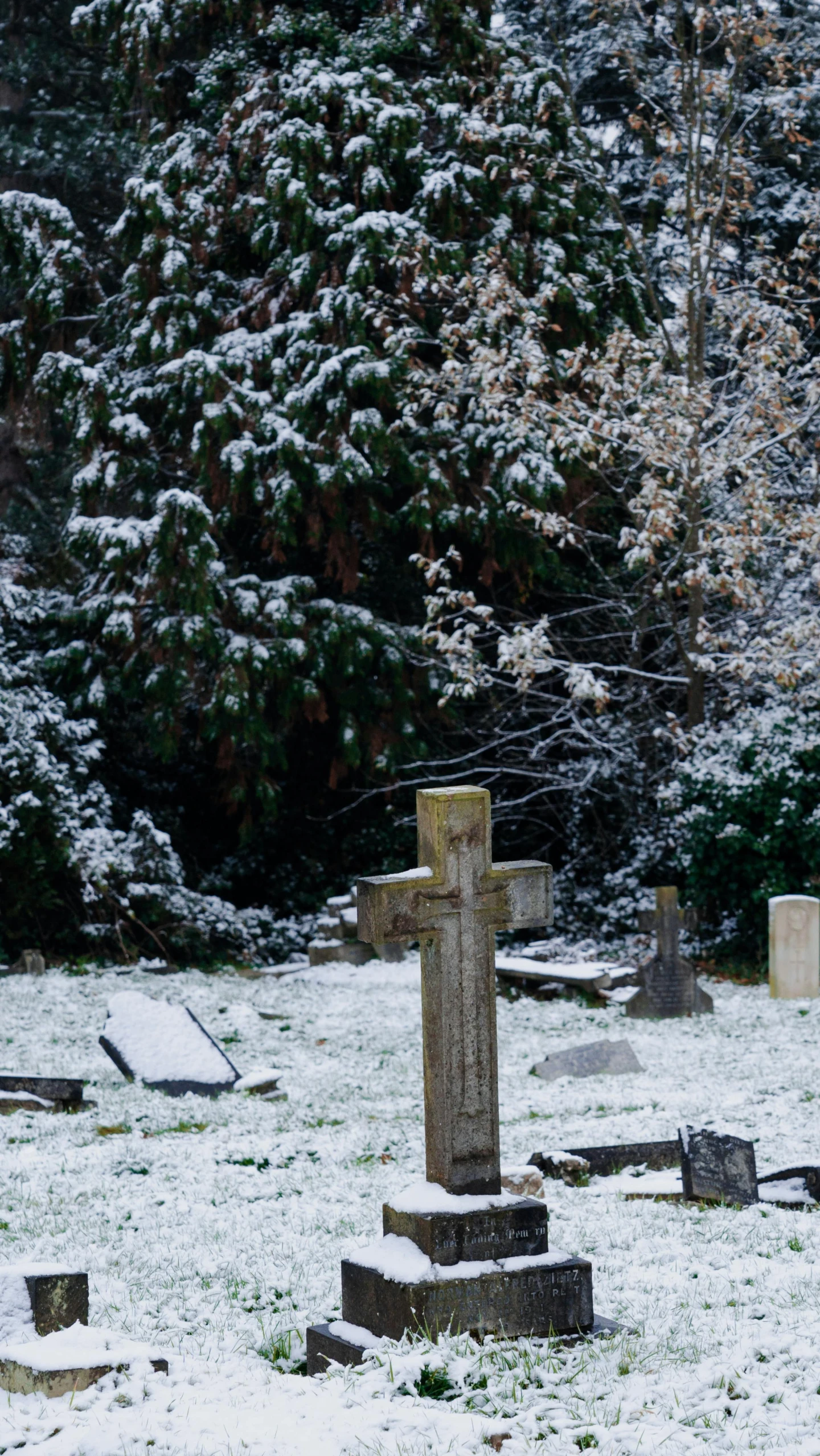 a large wooden cross sitting in the middle of a snow covered field