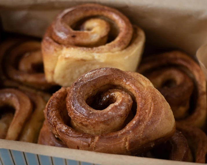 cinnamon rolls in a box ready to be eaten