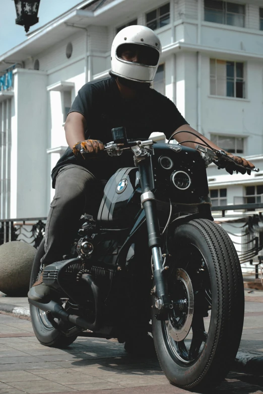 a man is sitting on his motorcycle at the park