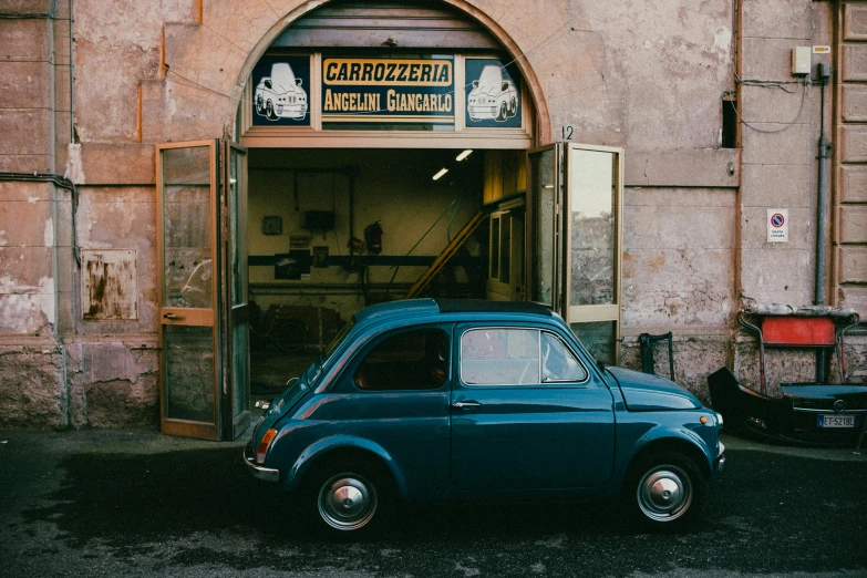 a small car parked in front of a door