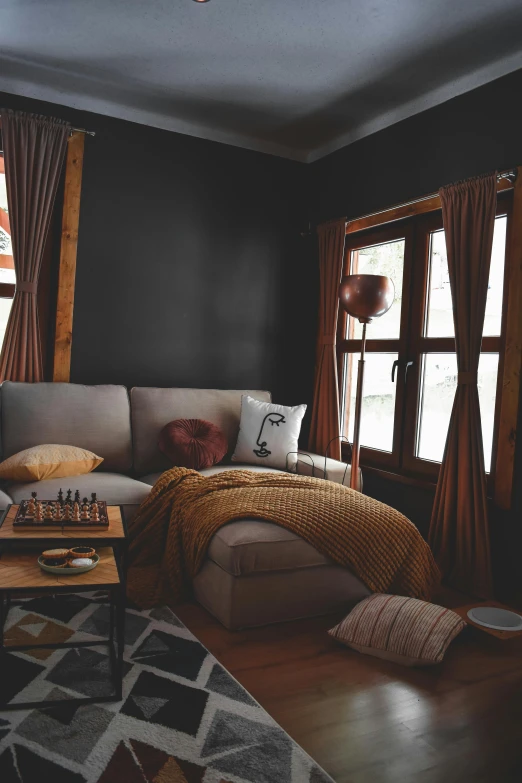 the living room has black walls and wooden floors