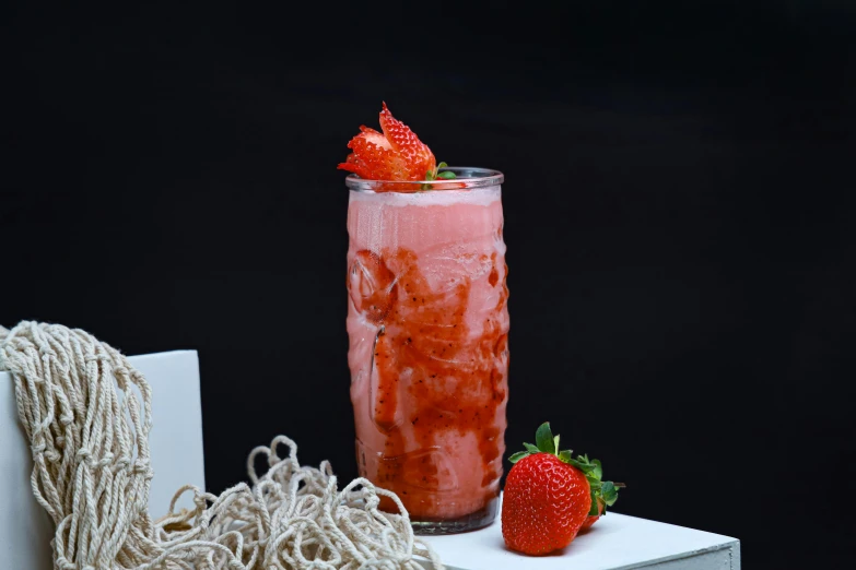 a strawberry soda and strawberries sit on display