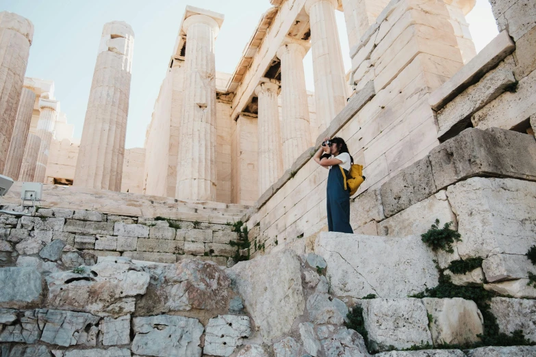 woman taking a selfie in front of part of the temple