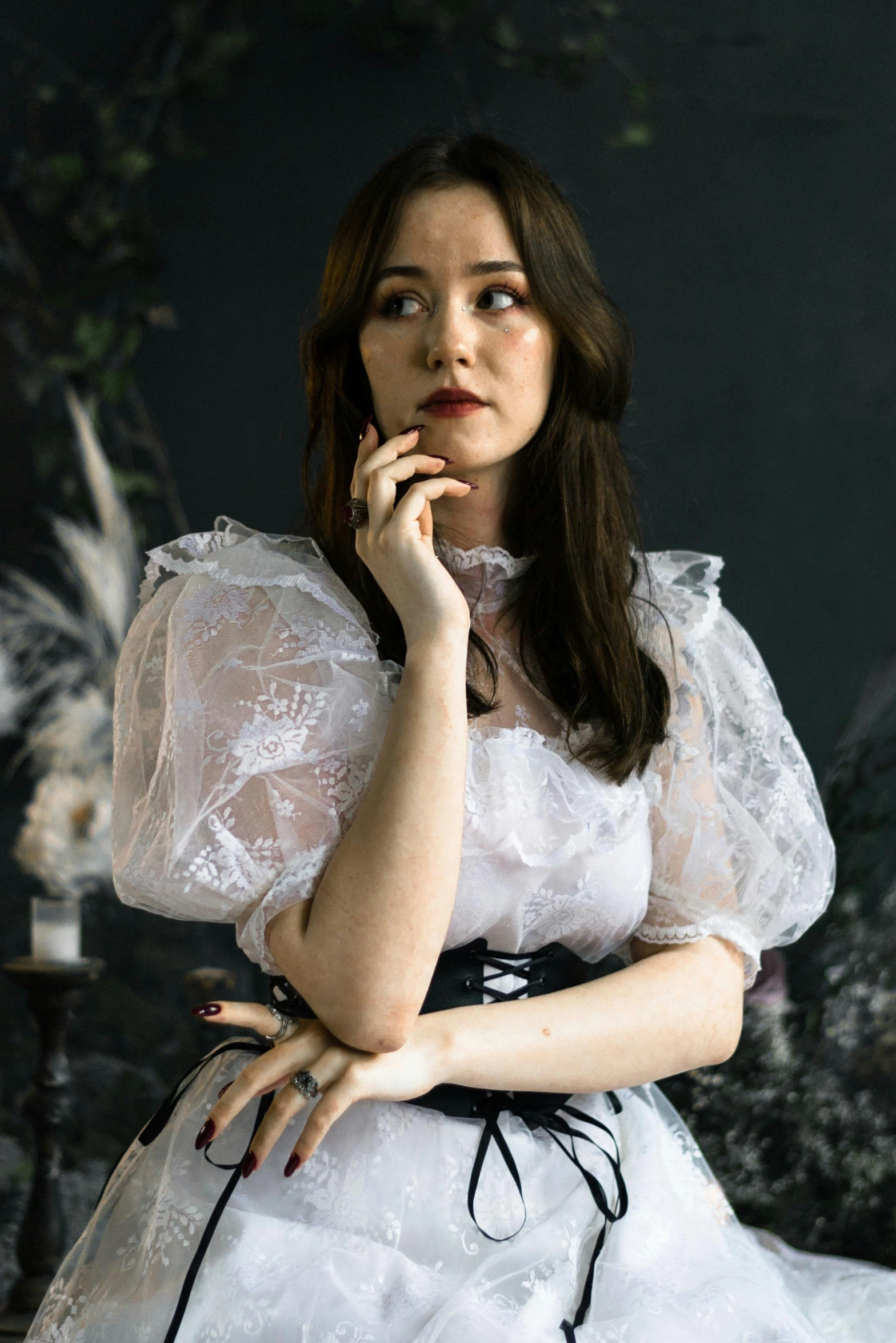 a woman is dressed in white clothing posing for the camera