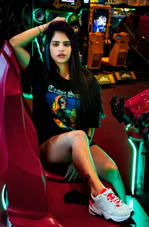 a beautiful young lady sitting on top of a red chair