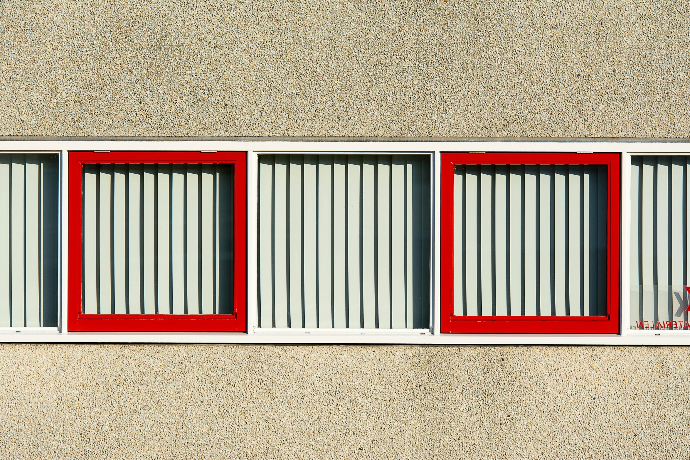 the windows on this building are red, white and gray