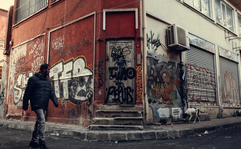 a person is walking down a street near a building