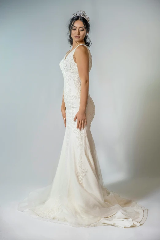 a woman wearing a white dress standing on a white background