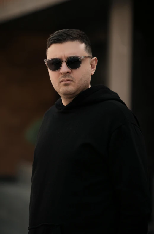 a young man with sunglasses on posing for a picture