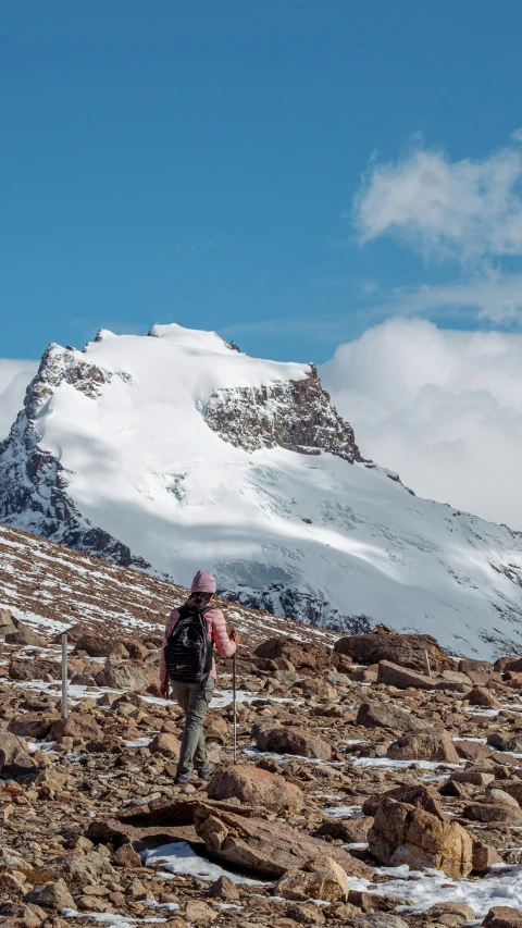 man standing on rocks on top of a mountain