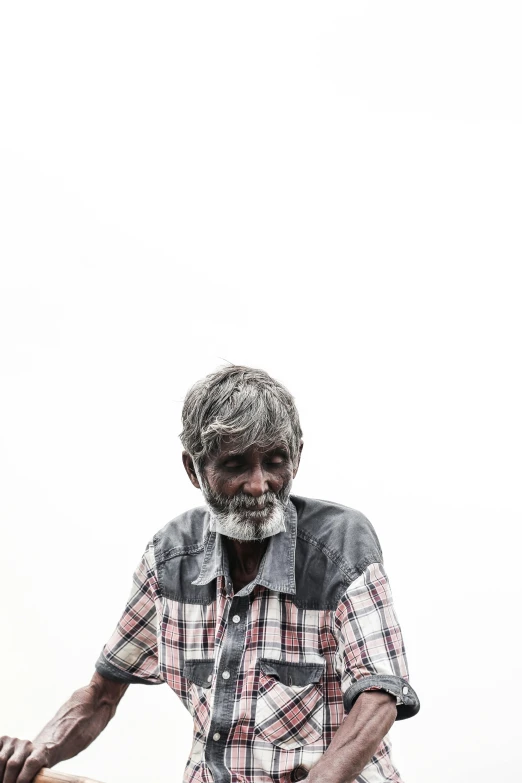 a man holds a stick that is made of wood