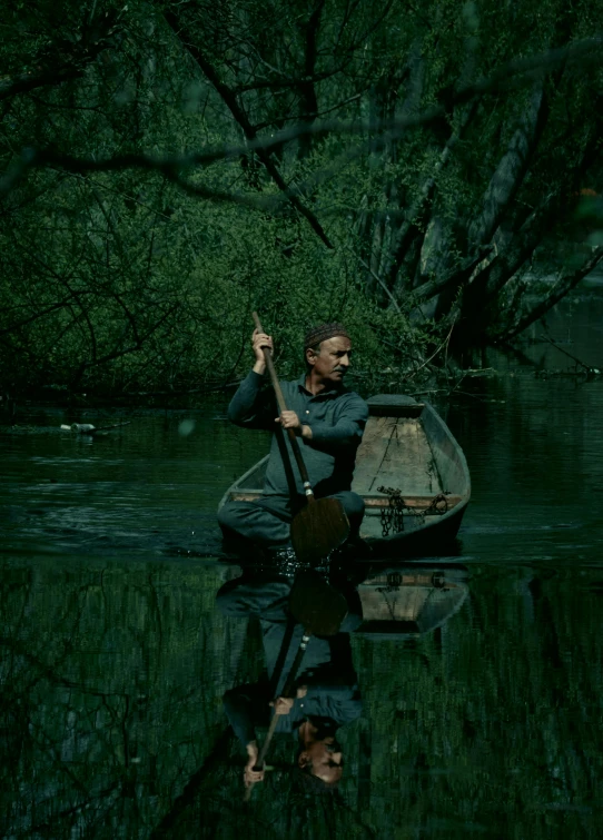 a man riding on top of a boat across water