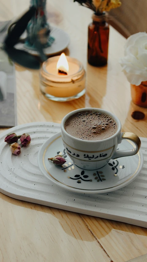 a cappuccino with a candle and tea bags