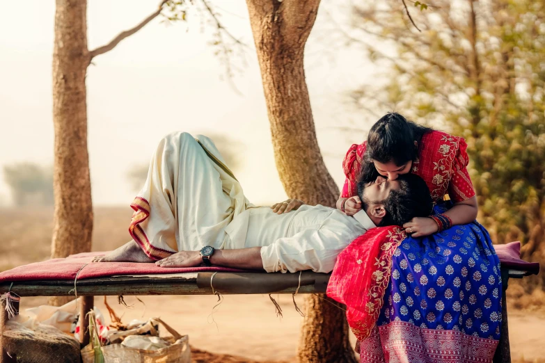 the woman with two children is sitting on the bed