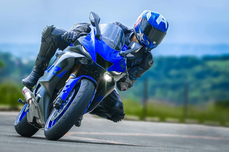 a blue motorcycle leans down on its left side