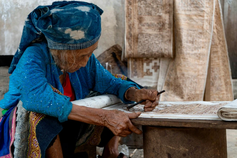 a women working on soing at her table