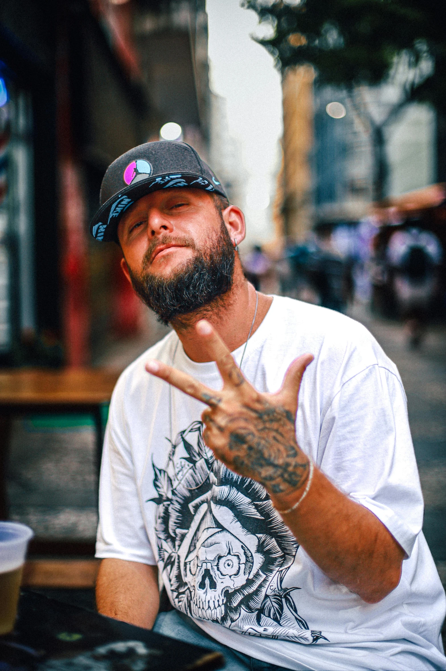 a man sitting in a chair making the peace sign