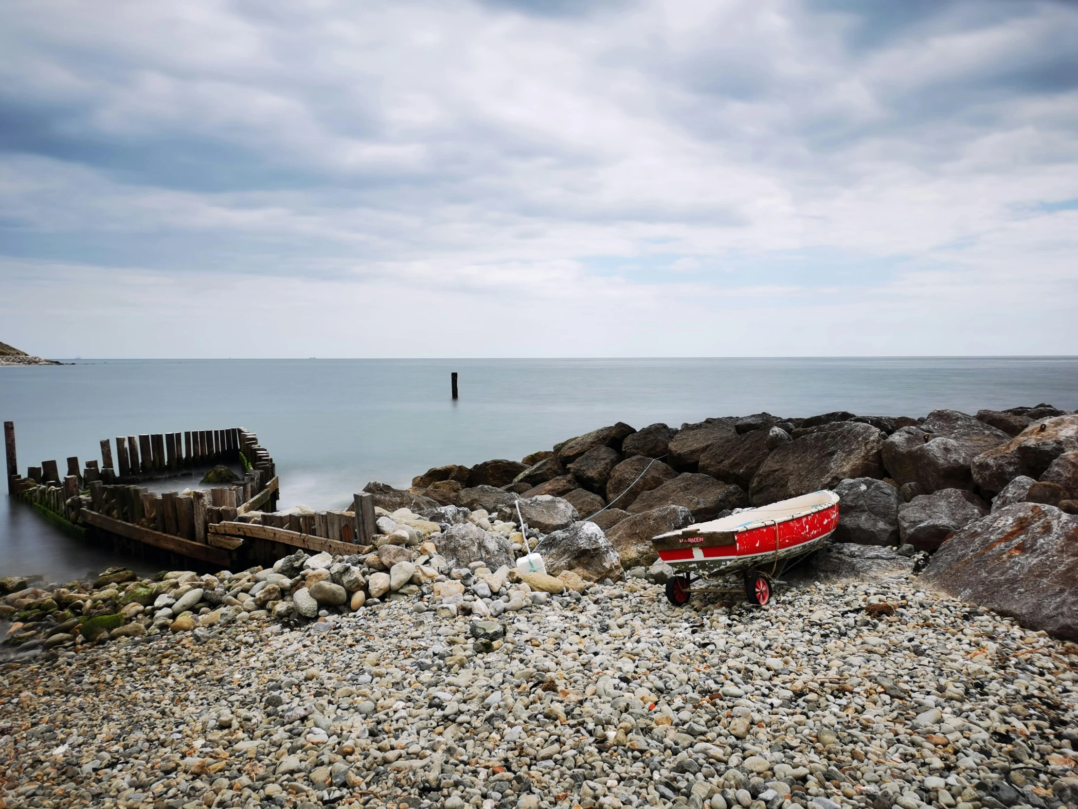 a boat on the rocks by the beach