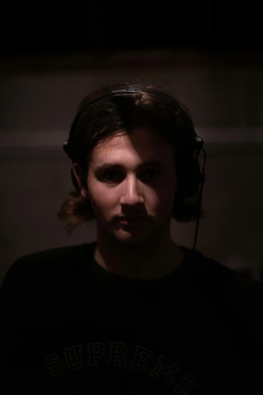 a man wearing headphones with long hair