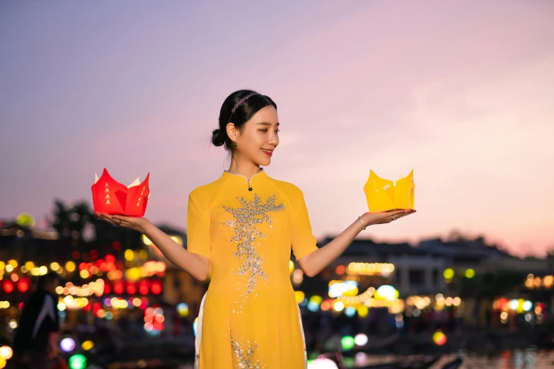 a woman is holding up red and yellow pieces