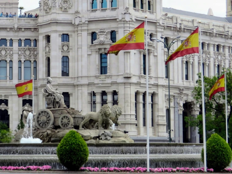 flags fly in the wind at the stately buildings