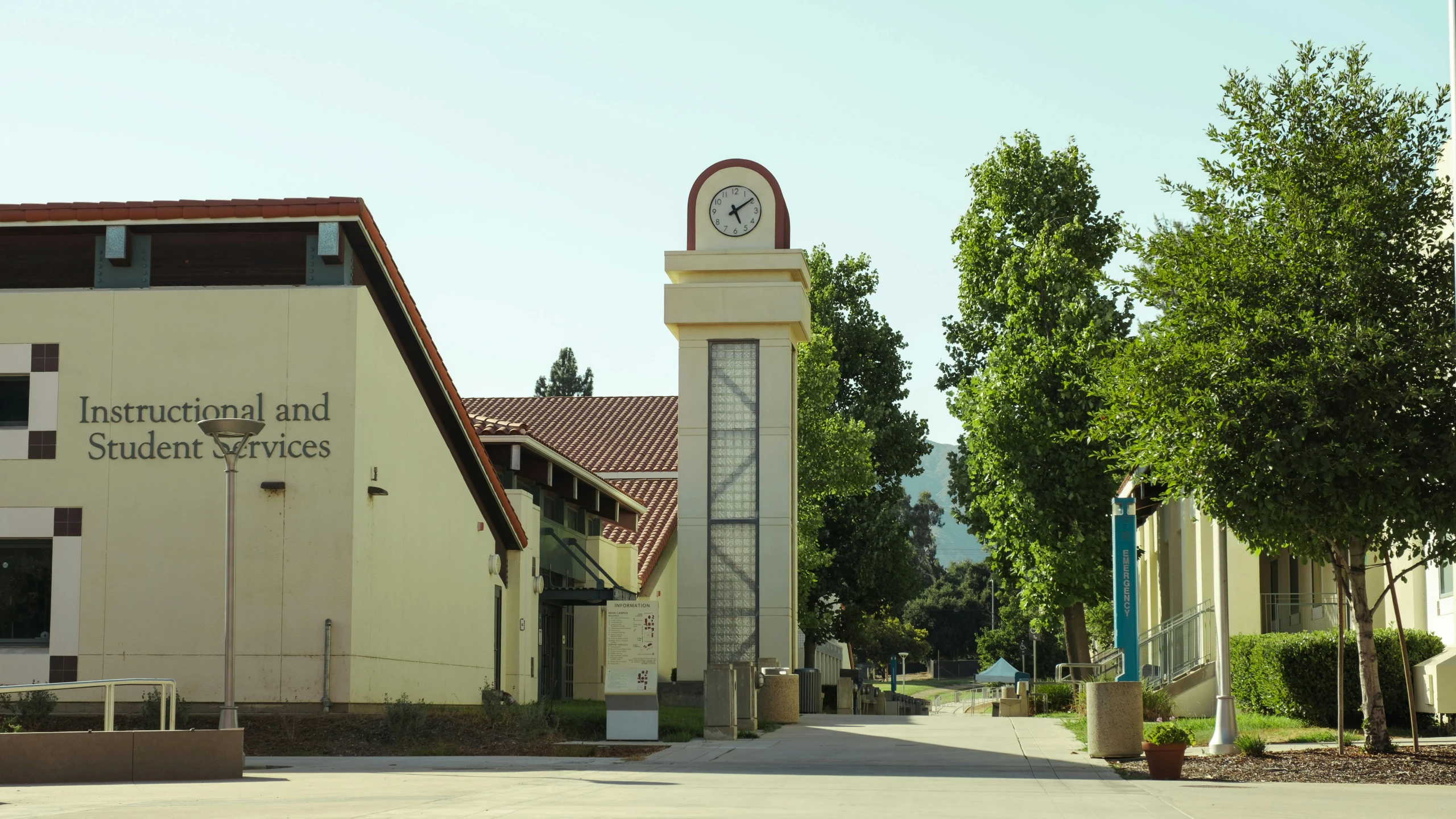 a building with a clock tower and flags