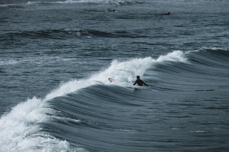 a man in the water holding a surfboard while riding a wave