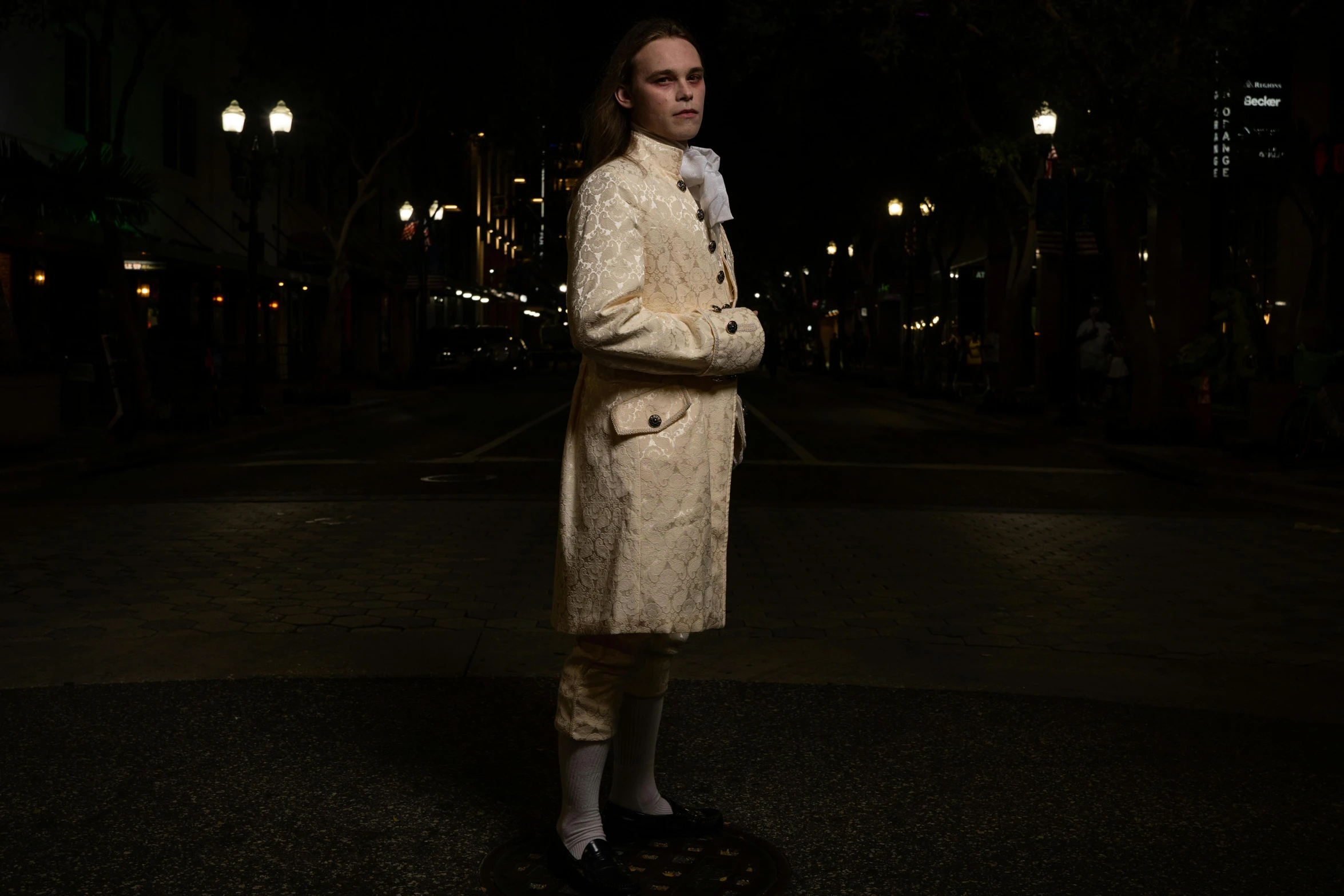 a woman standing on a skate board at night