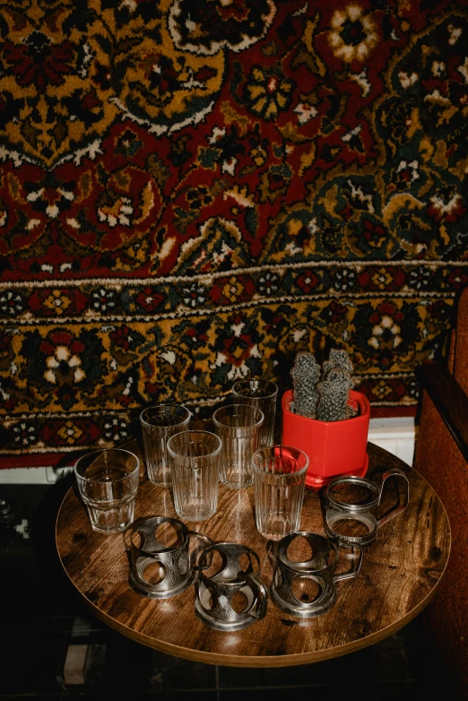 a round table with empty drinking glasses on it