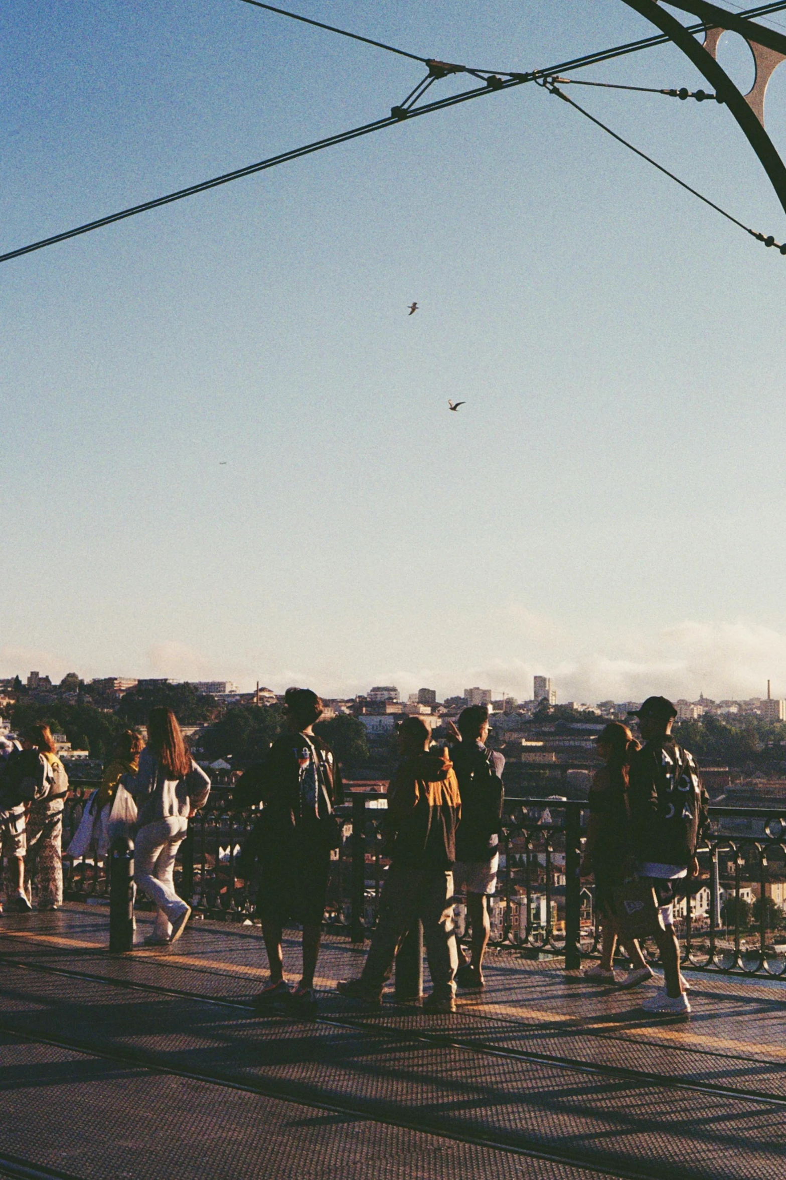 a group of people are standing in the shade