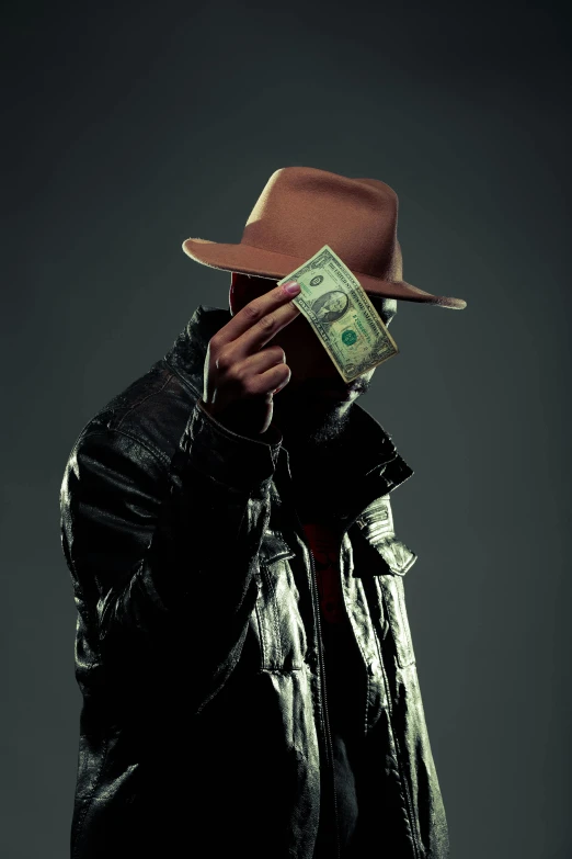 a man holding a stack of money up to his face