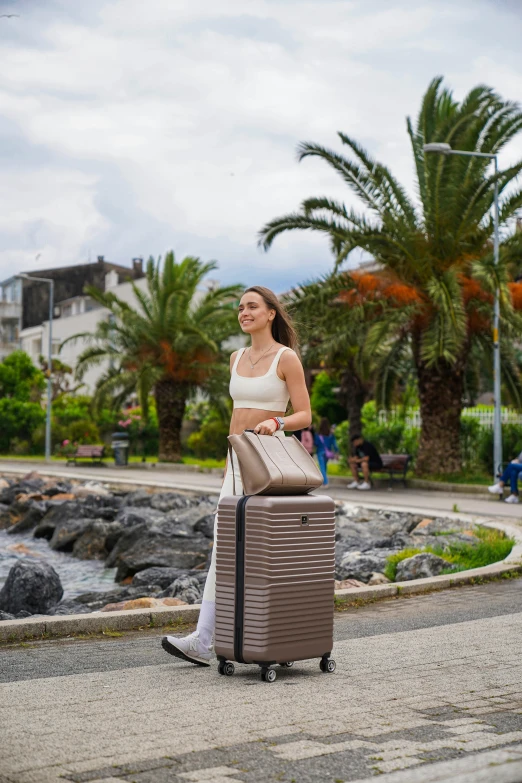 a woman is pulling a large piece of luggage