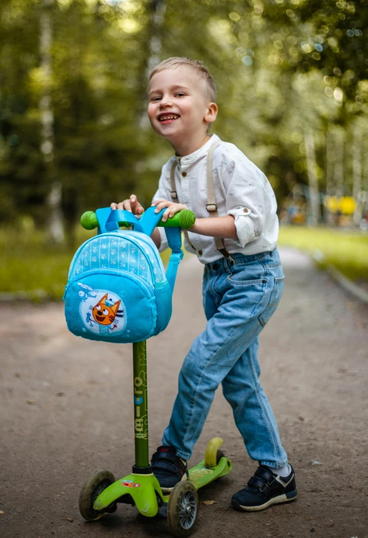 a little boy riding a blue scooter with fish