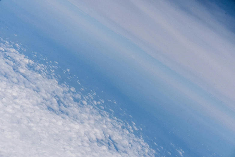 the image shows a bright blue sky and some fluffy clouds