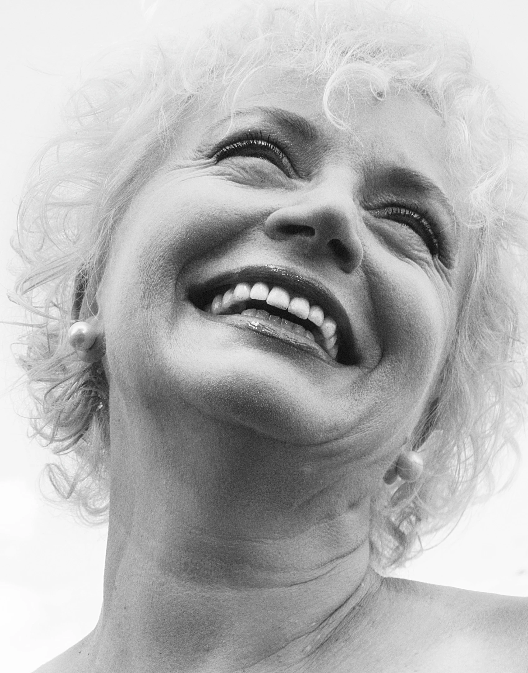 a black and white image of a person laughing