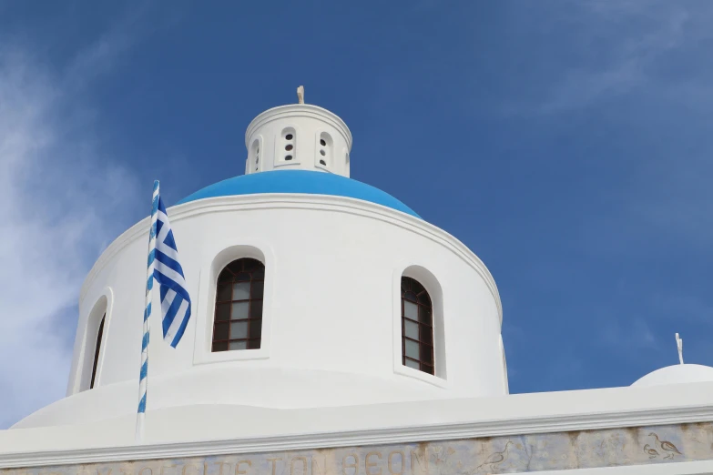 a white building has a blue dome and windows