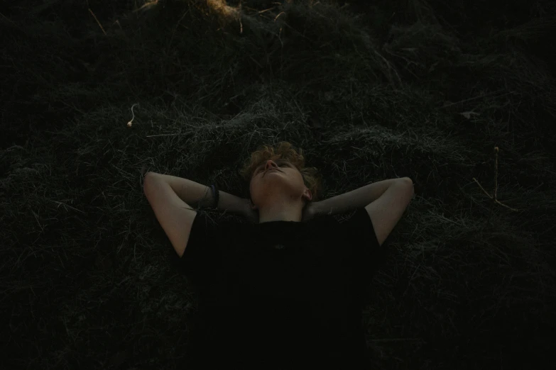 a person laying in the grass during a nighttime