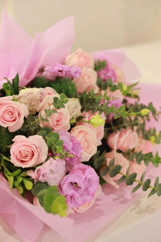 a large bouquet of pink flowers with green stems
