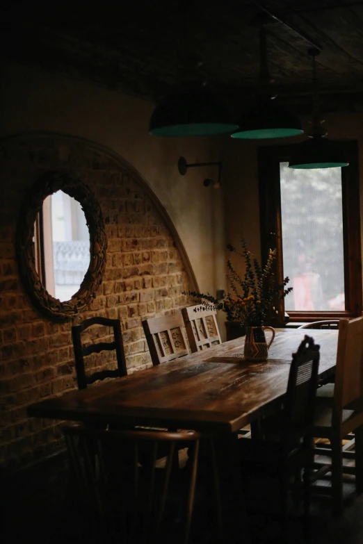 a wooden table sitting in front of a window