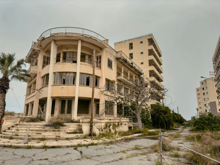 an old building with lots of balconies and trees in front of it